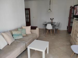 a living room with a couch and a table at Vive Huelva ARAGON 4 HABITACIONES WIFI 300MB in Huelva