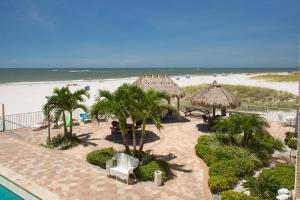 a resort with a sandy beach and a beach at 103 - Sandy Shores in St. Pete Beach