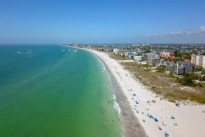 an aerial view of a beach with people and the ocean at 103 - Sandy Shores in St. Pete Beach