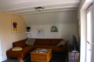 a living room with a couch and a coffee table at Haus Reiher am Lauwersmeere176 in Anjum