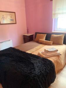 a bedroom with a bed with a black blanket on it at Charming house with mountain view in Manteigas, fireplace in Manteigas