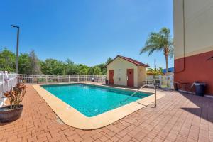a swimming pool on a brick patio next to a building at Sleep Inn Leesburg Chain of Lakes in Leesburg