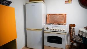 a kitchen with a white stove and a refrigerator at Semaldi Orient in Sarajevo