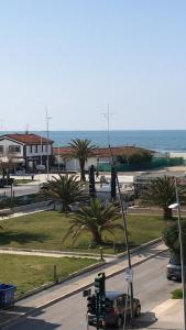 een verkeerslicht op een straat met de oceaan op de achtergrond bij my happy place in Lido di Camaiore
