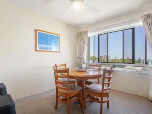 a dining room with a table and chairs and a window at Cheltenham Apartments Unit 11 40 King St in Caloundra