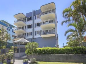 a building with balconies and palm trees in front of it at Cheltenham Apartments Unit 11 40 King St in Caloundra