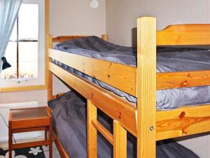 a wooden bunk bed in a room with a window at 4 person holiday home in Mörbylånga-By Traum in Mörbylånga