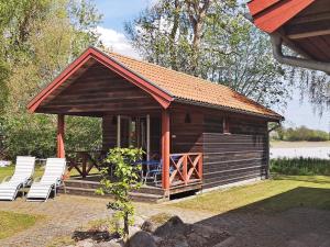 a log cabin with chairs and a table and a table at 4 person holiday home in Mörbylånga-By Traum in Mörbylånga +27 photos
