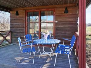 a table and chairs on the porch of a cabin at 4 person holiday home in Mörbylånga-By Traum in Mörbylånga