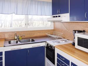 a kitchen with blue cabinets and a sink at Holiday home Mörbylånga V in Mörbylånga