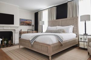 a bedroom with a large bed and a fireplace at The Federal in Brunswick