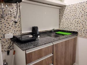 a kitchen counter with a sink and a phone on it at Monoambiente San Francisco in San Francisco
