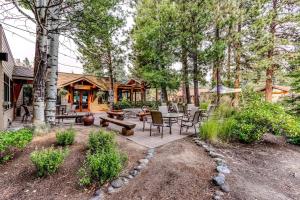 a patio with a table and chairs in front of a cabin at Seventh Mountain Resort in Bend