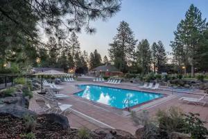 a large swimming pool with chairs at Seventh Mountain Resort in Bend