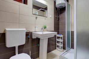 a bathroom with a sink and a toilet and a shower at Apartments Vesna in Tivat +46 photos