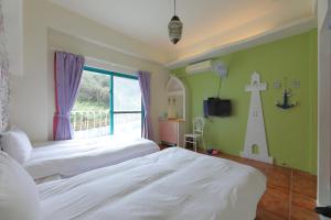 Postel nebo postele na pokoji v ubytování Rainbow B&B