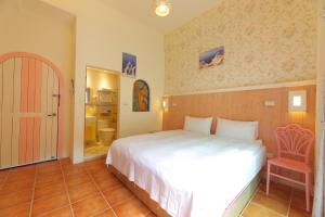 Postel nebo postele na pokoji v ubytování Rainbow B&B