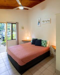 a bedroom with a large bed in a room at Daintree Siesta in Diwan