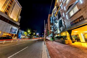 an empty street in a city at night at Charlie Hotel Jeju in Jeju