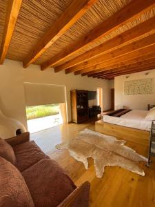 a living room with a bed and a couch at Casa Luna in San Pedro de Atacama