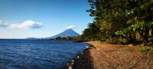 a view of a mountain and a body of water at Hostal La Cascada in Mérida