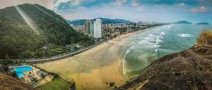 an aerial view of a beach and a city at Blue Hale in Guarujá