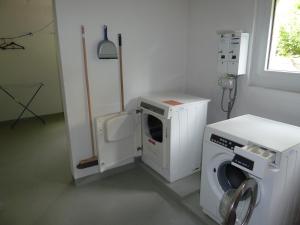 uma máquina de lavar e secar roupa num quarto em Ferienwohnung Murschetg em Laax