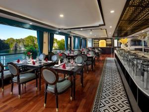 a restaurant on a train with tables and chairs at Aspira Cruise in Ha Long