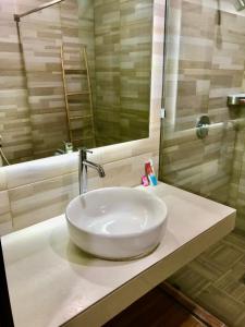 a white sink on a counter in a bathroom at Aman Gati Hotel Lakey in Huu