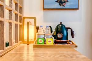 a wooden tray with a tea kettle and other items at Happy Dragon Universal Vacation Hotel - close to Universal Studio and Wanda Plaza,free shuttle to the Resort,Free Coffee,Laundry in Beijing