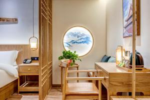 a room with a bed and a desk and a bed and a bedroom at Happy Dragon Universal Vacation Hotel - close to Universal Studio and Wanda Plaza,free shuttle to the Resort,Free Coffee,Laundry in Beijing