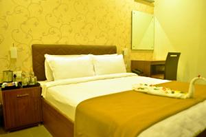 Postel nebo postele na pokoji v ubytování Hotel Arunachala