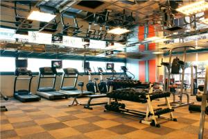 a gym with several tread machines in a room at Imperial Hotel Miri in Miri