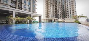 a large blue swimming pool with two tall buildings at Sunway Paradise Home Staycation PH2100 SELF CHECK IN OUT in Subang Jaya