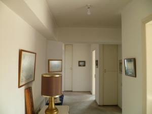 a hallway with a room with a lamp on a table at Room in Guest room - Datacom House - The Sky Blue Room in Nicosia