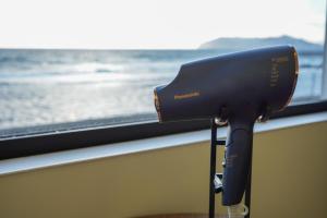 a hair dryer sitting in front of a window at Sinori205 in Hakodate