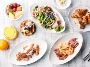 four plates of food on a white table at Kobe Meriken Park Oriental Hotel in Kobe