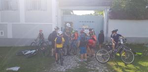 a group of people standing next to their bikes at Pensiunea Ramona in Viscri