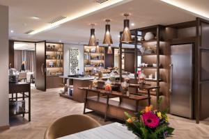 a room with a bar with flowers on a table at InterContinental Perth City Centre, an IHG Hotel in Perth