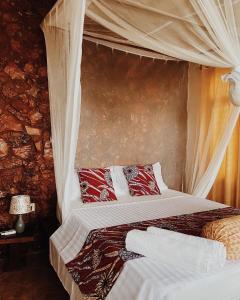 a bedroom with two beds with a canopy at Villa Fiona in Marumbi +60 photos