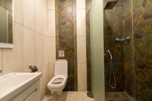 a bathroom with a toilet and a sink and a shower at Terem Inn in Karagandy +26 photos