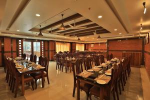 a large banquet hall with long tables and chairs at Lemongrass inn munnar in Anachal