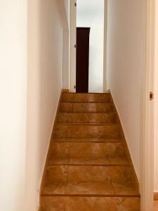 a stairway leading to a hallway with white walls and wooden floors at Apartamento sureño in Cádiz