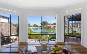 a dining room with a view of the water at Islander Escape in Encounter Bay