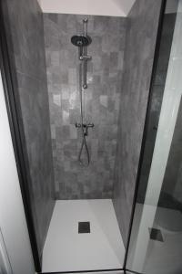 cabina de ducha con puerta de cristal y ducha en DU SEL A LA VIE, grand studio entre marais et océan, en Batz-sur-Mer