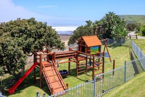 a playground with a slide and a play structure at Morgan Bay Hotel in Morganʼs Bay