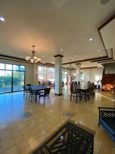 a dining room with tables and chairs in a building at MC Mountain Home in Tagaytay