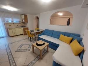 a living room with a blue couch and a table at Apartments Vesna in Bled