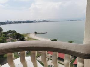 a view of the ocean from a balcony at Beach View Private Apartment in Port Dickson