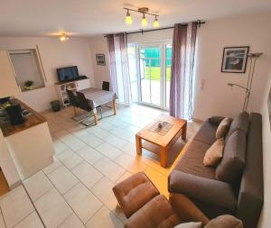 a living room with a couch and a table at Ferienwohnungen Saida Wohnung 11 in Norden +13 photos
